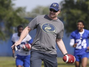 Winnipeg Blue Bombers Head Coach Mike O'Shea tosses an errant pass back to players during a team mini-camp at IMG Academy in Bradenton Florida on Thursday, April 25, 2019.

Photo by Tom O'Neill