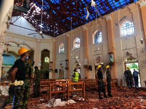 Security personnel inspect the interior of St. Sebastian's Church in Negombo on April 22, 2019, a day after the church was hit in series of bomb blasts targeting churches and luxury hotels in Sri Lanka. ISHARA S. KODIKARA/AFP/Getty Images