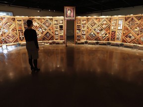 Visitors to the Canadian Museum for Human Rights in Winnipeg can view a new exhibit called The Witness Blanket Monday, December 14, 2015. The Canadian Museum for Human Rights and First Nations artist Carey Newman are signing an agreement regarding the protection and use of "The Witness Blanket." The 12-metre-long, cedar-framed installation is comprised of more than 800 items collected from the sites and survivors of residential schools assembled in the style of a woven blanket.