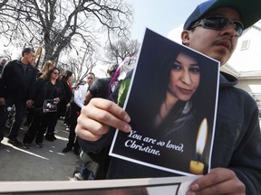 During a march for Christine Wood, Byron Wood holds a photo of his sister as his parents Melinda and George stop outside the house where police believe Wood was killed in Winnipeg, Wednesday, April 12, 2017. A prosecutor says a Manitoba man on trial for killing a young Indigenous woman met her on a popular online dating site. Brett Overby, who is 32, is charged with second-degree murder in the 2016 death of Christine Wood.