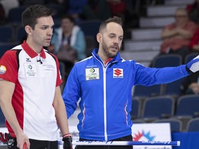 Switzerland skip Peter de Cruz and Italy skip Joel Retornaz chat at the Men's World Curling Championship in Lethbridge, Alta. on Thursday, April 4, 2019.