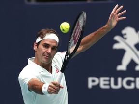 Roger Federer, of Switzerland, returns to John Isner during the singles final of the Miami Open tennis tournament, Sunday, March 31, 2019, in Miami Gardens, Fla.