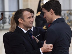 French President Emmanuel Macron greets Prime Minister Justin Trudeau as he arrives in Paris, France Sunday November 11, 2018. Canada's focus on gender at the G7 summit last year has translated into a successful legacy for the annual meeting of world leaders. THE CANADIAN PRESS/Adrian Wyld ORG XMIT: CPT504