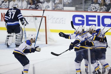 St. Louis Blues celebrate Tyler Bozak's (21) game winning goal against the Winnipeg Jets during third period NHL playoff action in Winnipeg on Wednesday, April 10, 2019. THE CANADIAN PRESS/John Woods