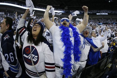 Winnipeg Jets' fans celebrate Winnipeg Jets right wing Patrik Laine's goal during first period NHL playoff action against the St. Louis Blues in Winnipeg on Wednesday, April 10, 2019. THE CANADIAN PRESS/John Woods