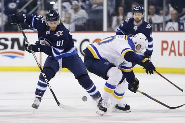 Winnipeg Jets left wing Kyle Connor (81) gets past St. Louis Blues centre Oskar Sundqvist (70) during second period NHL playoff action in Winnipeg on Wednesday, April 10, 2019. THE CANADIAN PRESS/John Woods