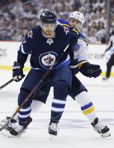 Winnipeg Jets centre Adam Lowry (17)gets around St. Louis Blues centre Ivan Barbashev (49) during second period NHL playoff action in Winnipeg on Wednesday, April 10, 2019. THE CANADIAN PRESS/John Woods
