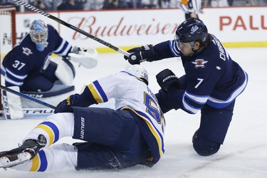 Winnipeg Jets defenceman Ben Chiarot (7) defends against St. Louis Blues defenceman Colton Parayko (55) as Winnipeg Jets goaltender Connor Hellebuyck (37) watches for the puck during first period NHL playoff action in Winnipeg on Wednesday, April 10, 2019. THE CANADIAN PRESS/John Woods