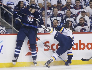 Winnipeg Jets defenceman Tyler Myers (57) checks St. Louis Blues left wing Zach Sanford (12) during first period NHL playoff action in Winnipeg on Wednesday, April 10, 2019. THE CANADIAN PRESS/John Woods