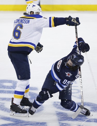 Winnipeg Jets' Mathieu Perreault (85) gets checked by St. Louis Blues' Joel Edmundson (6) during third period NHL playoff action in Winnipeg on Wednesday, April 10, 2019. THE CANADIAN PRESS/John Woods