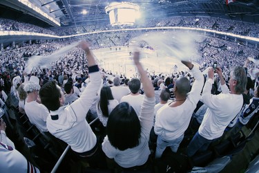 Winnipeg Jets' fans celebrate during first period NHL playoff action against the St. Louis Blues in Winnipeg on Wednesday, April 10, 2019. THE CANADIAN PRESS/John Woods