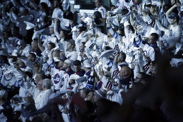 Winnipeg Jets' fans celebrate during first period NHL playoff action against the St. Louis Blues in Winnipeg on Wednesday, April 10, 2019. THE CANADIAN PRESS/John Woods