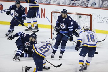 St. Louis Blues centre Tyler Bozak (21) scores the game winning goal on Winnipeg Jets goaltender Connor Hellebuyck (37) as Jets defenceman Tyler Myers (57) and Jets right wing Kevin Hayes (12) defend during third period NHL playoff action in Winnipeg on Wednesday, April 10, 2019. THE CANADIAN PRESS/John Woods