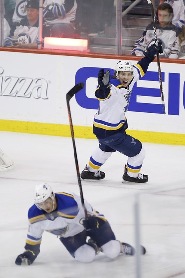 St. Louis Blues' Robert Thomas (18) and Tyler Bozak (21) celebrate Bozak's game winning goal against the Winnipeg Jets during third period NHL playoff action in Winnipeg on Wednesday, April 10, 2019. THE CANADIAN PRESS/John Woods