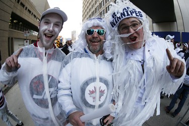 Fans Brendan, Glenn and Shane Luff gather for the Winnipeg Jets White Out Party prior to first round NHL playoffs action between the Jets and St. Louis Blues in Winnipeg on Wednesday, April 10, 2019. THE CANADIAN PRESS/John Woods