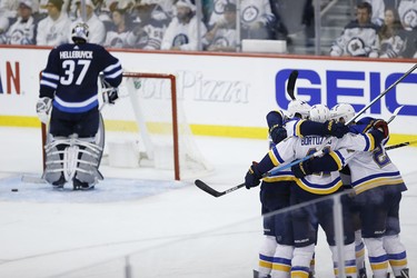 St. Louis Blues celebrate Tyler Bozak's (21) game winning goal against the Winnipeg Jets during third period NHL playoff action in Winnipeg on Wednesday, April 10, 2019. THE CANADIAN PRESS/John Woods
