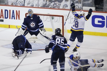 Winnipeg Jets goaltender Connor Hellebuyck (37) reacts after missing the game winning shot by St. Louis Blues' Tyler Bozak (21) during third period NHL playoff action in Winnipeg on Wednesday, April 10, 2019. THE CANADIAN PRESS/John Woods