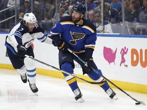 St. Louis Blues left wing Pat Maroon is defended by Winnipeg Jets' Ben Chiarot during the second period in Game 4 of an NHL first-round hockey playoff series Tuesday in St. Louis.