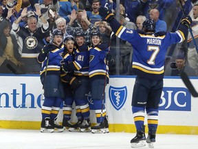 St. Louis Blues' Jaden Schwartz, second from left, is congratulated by teammates Vince Dunn, left, Tyler Bozak (21), Tyler Bozak and Pat Maroon (7) after scoring during the second period in Game 6 of an NHL first-round hockey playoff series against the Winnipeg Jets, Saturday in St. Louis.