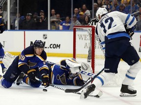 Winnipeg Jets' Kevin Hayes (12) is unable to score past past St. Louis Blues' Jay Bouwmeester (19) and goaltender Jordan Binnington during the first period in Game 3 of an NHL first-round hockey playoff series Sunday in St. Louis.