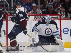 Colorado Avalanche center Carl Soderberg (34) scores against Winnipeg Jets goaltender Connor Hellebuyck (37) during the third period of an NHL hockey game in Denver, Thursday, April 4, 2019. Colorado won 3-2 in overtime. (AP Photo/Joe Mahoney) ORG XMIT: COJM109