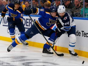 St. Louis Blues’ Vladimir Tarasenko knocks the Jets’ Josh Morrissey off the puck in Game Three at the Enterprise Center Sunday night. (Getty images)