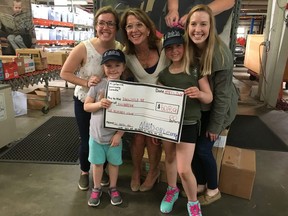 Winnipeg Jets fan Madison Leferink, 6, (front left) brings a donation to St. Louis, Miss., charity Little Bit before attending Tuesday's Jets game against the St. Louis Blues with her mom Shauna (right) and sister Jordyn (front right).
Handout