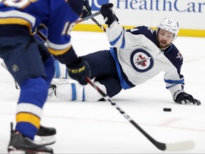 Jets’ Josh Morrissey slides to block the puck during the second period of Game 4 on Tuesday night against the Blues in St. Louis. AP