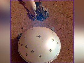 This photo made available by NASA on Tuesday, April 23, 2019 shows the InSight lander's domed wind and thermal shield which covers a seismometer on the 110th Martian day, or sol, of the mission.