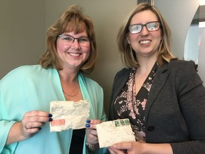 Sonya Berthin and Rose Mackesey, with McCor Management, pose with letters found during construction on a historic building in Winnipeg in this recent handout photo. Century-old love letters are being returned to a family after they were uncovered by a construction crew working on a historic building in Manitoba. The letters from 1918 and 1919 are addressed to a Rebecca "Becky" Rusoff in Winnipeg from a soldier in Halifax named "Soko."