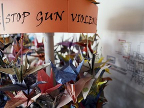 FILE - In this March 23, 2019, file photo, origami cranes, a symbol of peace, hang in the Columbine High School library in Littleton, Colo., near where several survivors and family members of the victims gathered to speak about the upcoming 20th anniversary of the April 20, 1999, shooting. In the two decades since the Columbine High School massacre, therapists still struggle with how to help people cope.