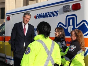 Premier Brian Pallister speaks with paramedics on Monday, April 1, 2019, prior to announcing that his government will complete its election promise to reduce ambulance fees by half during this term of office. The final rate takes effect immediately. 
JOYANNE PURSAGA/Winnipeg Sun/Postmedia Network