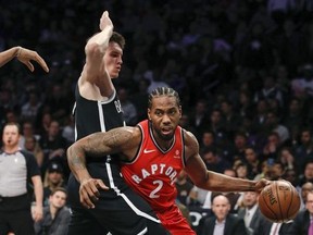 Brooklyn Nets forward Rodions Kurucs guards Toronto Raptors forward Kawhi Leonard during the first half of an NBA basketball game Wednesday, April 3, 2019, in New York.