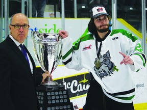 MJHL commissioner, Kim Davis, presents the Turnbull Cup to Braden Billaney of the Portage Terriers. A lengthy suspension kept the veteran forward out of the lineup for the entire postseason however the Boissevain, Man., native is eligible to return in Game 2 of the ANAVET Cup.