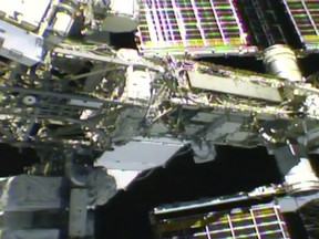 In this photo provided by NASA, NASA astronaut Anne McClain works outside the International Space Station, Monday, April 8, 2019. McClain and Canadian astronaut David Saint-Jacques got an early start Monday morning as they tackled battery and cable work outside the International Space Station. It's the third spacewalk in just 2 ½ weeks for the station crew. (NASA via AP) ORG XMIT: NYCD304