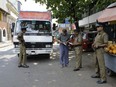 Sri Lankan police officers perform security checks on a truck at a roadside in Colombo, Sri Lanka, Thursday, April 25, 2019.