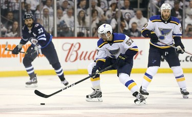 WINNIPEG, MANITOBA - APRIL 10: David Perron #57 of the St. Louis Blues moves the puck against the Winnipeg Jets in Game One of the Western Conference First Round during the 2019 NHL Stanley Cup Playoffs at Bell MTS Place on April 10, 2019 in Winnipeg, Manitoba, Canada. (Photo by Jason Halstead/Getty Images)