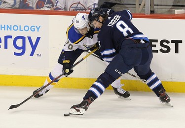 WINNIPEG, MANITOBA - APRIL 10: Oskar Sundqvist #70 of the St. Louis Blues battles Jacob Trouba #8 of the Winnipeg Jets in Game One of the Western Conference First Round during the 2019 NHL Stanley Cup Playoffs at Bell MTS Place on April 10, 2019 in Winnipeg, Manitoba, Canada. (Photo by Jason Halstead/Getty Images)