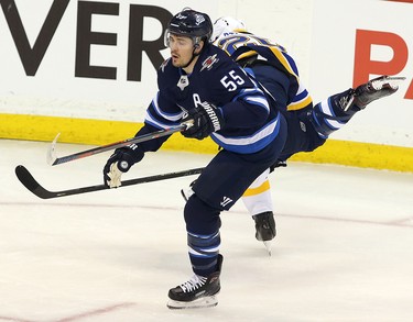 WINNIPEG, MANITOBA - APRIL 10: Mark Scheifele #55 of the Winnipeg Jets dodges a check in Game One of the Western Conference First Round against the St. Louis Blues during the 2019 NHL Stanley Cup Playoffs at Bell MTS Place on April 10, 2019 in Winnipeg, Manitoba, Canada. (Photo by Jason Halstead/Getty Images)