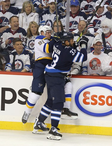 WINNIPEG, MANITOBA - APRIL 10: Dustin Byfuglien #33 of the Winnipeg Jets checks Vladimir Tarasenko #91 of the St. Louis Blues in Game One of the Western Conference First Round during the 2019 NHL Stanley Cup Playoffs at Bell MTS Place on April 10, 2019 in Winnipeg, Manitoba, Canada. (Photo by Jason Halstead/Getty Images)