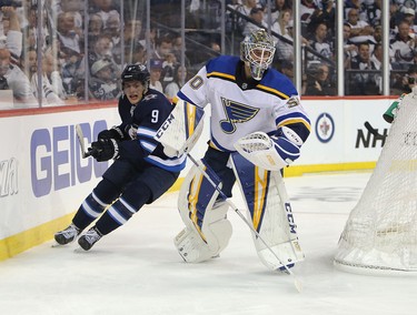 WINNIPEG, MANITOBA - APRIL 10: Andrew Copp #9 of the Winnipeg Jets chases the puck past Jordan Binnington #50 of the St. Louis Blues in Game One of the Western Conference First Round during the 2019 NHL Stanley Cup Playoffs at Bell MTS Place on April 10, 2019 in Winnipeg, Manitoba, Canada. (Photo by Jason Halstead/Getty Images)