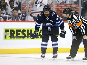 WINNIPEG, MANITOBA - APRIL 10: Dustin Byfuglien #33 of the Winnipeg Jets chats to a referee during a break in action with the St. Louis Blues in Game One of the Western Conference First Round during the 2019 NHL Stanley Cup Playoffs at Bell MTS Place on April 10, 2019 in Winnipeg, Manitoba, Canada. (Photo by Jason Halstead/Getty Images)