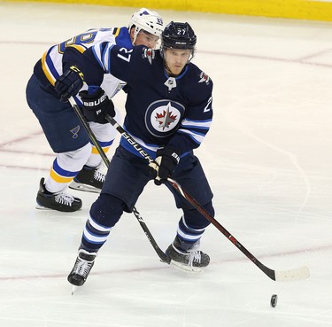 WINNIPEG, MANITOBA - APRIL 10: Nikolaj Ehlers #27 of the Winnipeg Jets looks to shoot in front of Vince Dunn #29 of the St. Louis Blues in Game One of the Western Conference First Round during the 2019 NHL Stanley Cup Playoffs at Bell MTS Place on April 10, 2019 in Winnipeg, Manitoba, Canada. (Photo by Jason Halstead/Getty Images)