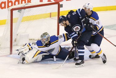 WINNIPEG, MANITOBA - APRIL 10: Jordan Binnington #50 of the St. Louis Blues makes a save under pressure from Bryan Little #18 of the Winnipeg Jets in Game One of the Western Conference First Round during the 2019 NHL Stanley Cup Playoffs at Bell MTS Place on April 10, 2019 in Winnipeg, Manitoba, Canada. (Photo by Jason Halstead/Getty Images)