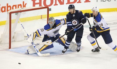 WINNIPEG, MANITOBA - APRIL 10: Jordan Binnington #50 of the St. Louis Blues makes a save under pressure from Bryan Little #18 of the Winnipeg Jets in Game One of the Western Conference First Round during the 2019 NHL Stanley Cup Playoffs at Bell MTS Place on April 10, 2019 in Winnipeg, Manitoba, Canada. (Photo by Jason Halstead/Getty Images)