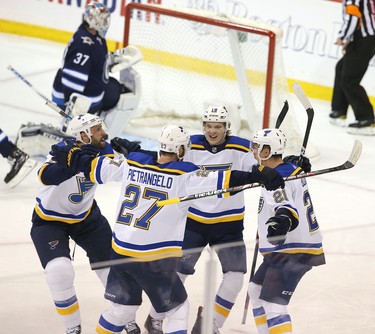 WINNIPEG, MANITOBA - APRIL 10: Tyler Bozak #21 of the St. Louis Blues and teammates celebrate Bozak's goal against the Winnipeg Jets in Game One of the Western Conference First Round during the 2019 NHL Stanley Cup Playoffs at Bell MTS Place on April 10, 2019 in Winnipeg, Manitoba, Canada. (Photo by Jason Halstead/Getty Images)