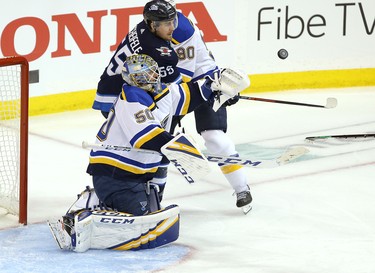 WINNIPEG, MANITOBA - APRIL 10: Jordan Binnington #50 of the St. Louis Blues makes a save in front of Mark Scheifele #55 of the Winnipeg Jets in Game One of the Western Conference First Round during the 2019 NHL Stanley Cup Playoffs at Bell MTS Place on April 10, 2019 in Winnipeg, Manitoba, Canada. (Photo by Jason Halstead/Getty Images)
