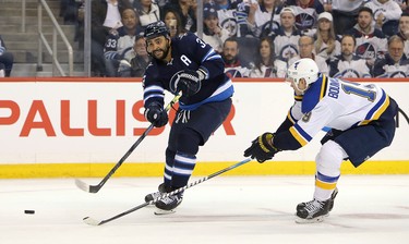 WINNIPEG, MANITOBA - APRIL 10: Dustin Byfuglien #33 of the Winnipeg Jets gets a shot away under pressure from Jay Bouwmeester #19 of the St. Louis Blues in Game One of the Western Conference First Round during the 2019 NHL Stanley Cup Playoffs at Bell MTS Place on April 10, 2019 in Winnipeg, Manitoba, Canada. (Photo by Jason Halstead/Getty Images)