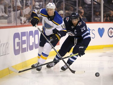 WINNIPEG, MANITOBA - APRIL 10: Jay Bouwmeester #19 of the St. Louis Blues and Blake Wheeler #26 of the Winnipeg Jets fight for a puck in Game One of the Western Conference First Round during the 2019 NHL Stanley Cup Playoffs at Bell MTS Place on April 10, 2019 in Winnipeg, Manitoba, Canada. (Photo by Jason Halstead/Getty Images)