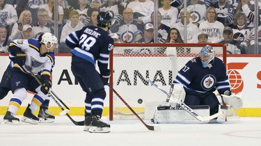 WINNIPEG, MANITOBA - APRIL 10: Connor Hellebuyck #37 of the Winnipeg Jets makes a savea against the St. Louis Blues in Game One of the Western Conference First Round during the 2019 NHL Stanley Cup Playoffs at Bell MTS Place on April 10, 2019 in Winnipeg, Manitoba, Canada. (Photo by Jason Halstead/Getty Images)